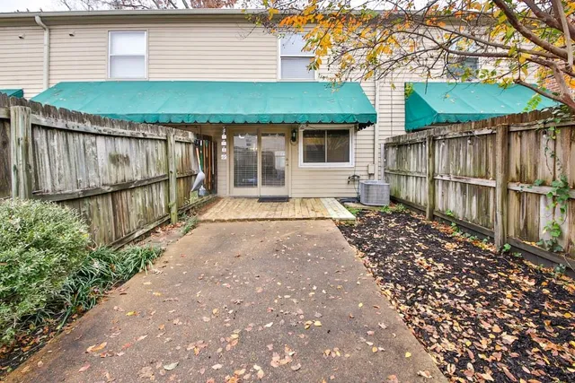 a front view of a house with a yard and outdoor seating