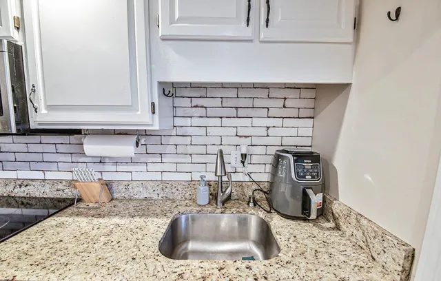 a kitchen with a refrigerator cabinets and wooden floor
