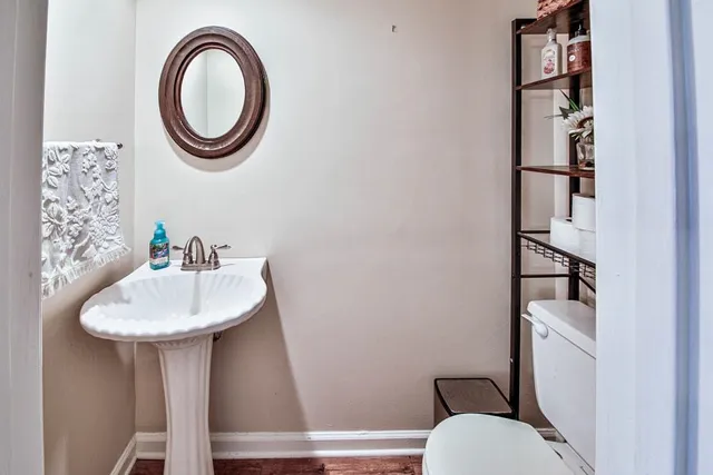 a bathroom with a sink a toilet and a mirror