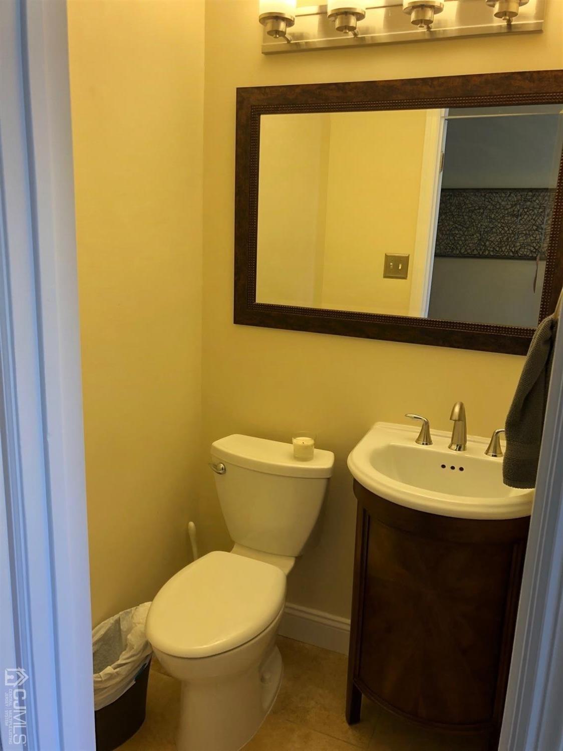 880 Robin Road Hillsborough, NJ 08844 - Photo 16 of 37 a bathroom with a toilet sink and mirror