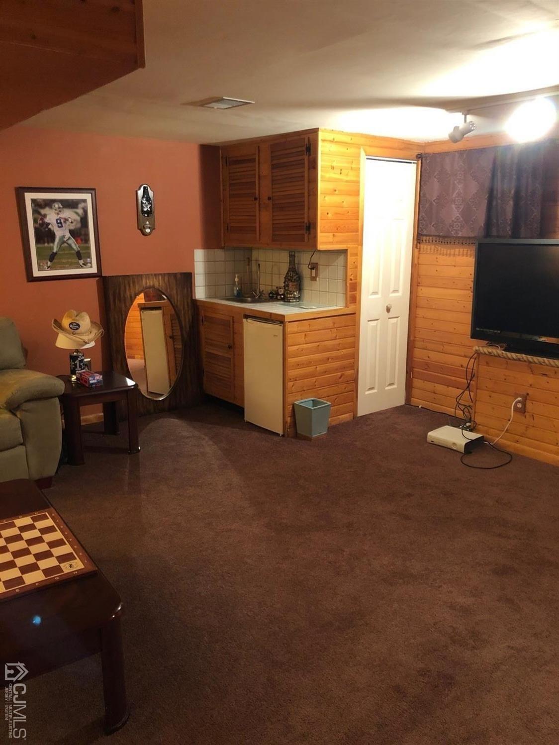880 Robin Road Hillsborough, NJ 08844 - Photo 20 of 37 a living room with furniture and a flat screen tv