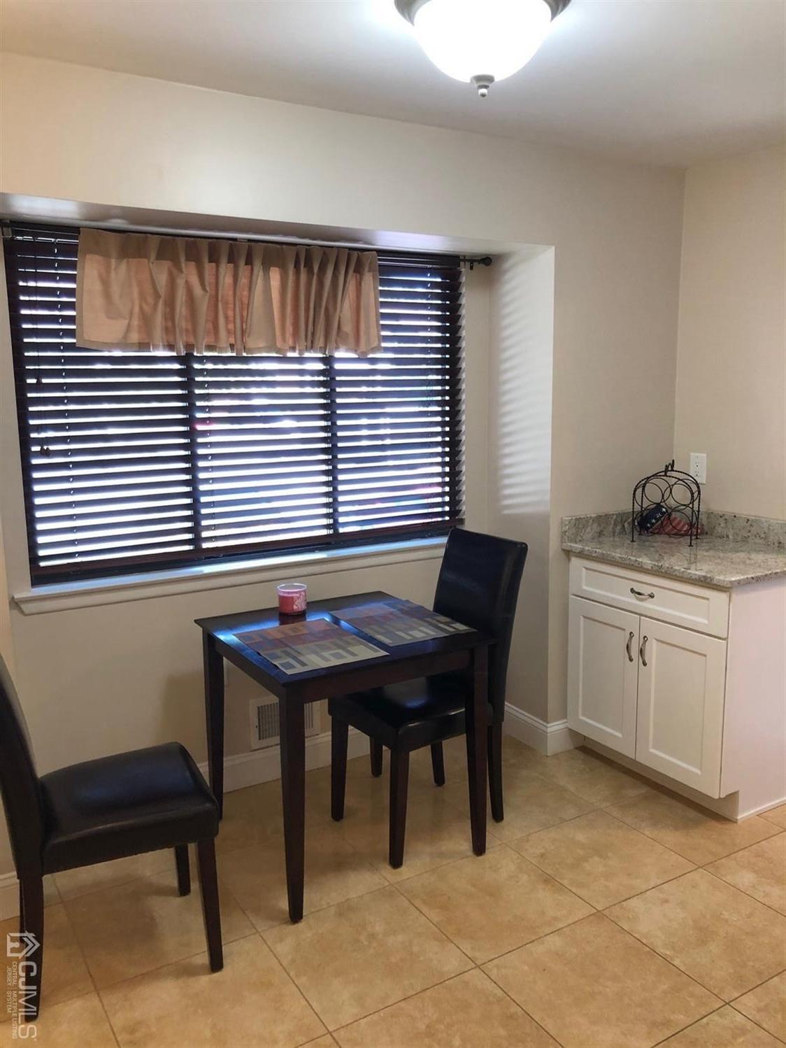 880 Robin Road Hillsborough, NJ 08844 - Photo 3 of 37 a kitchen with a table chairs and a window