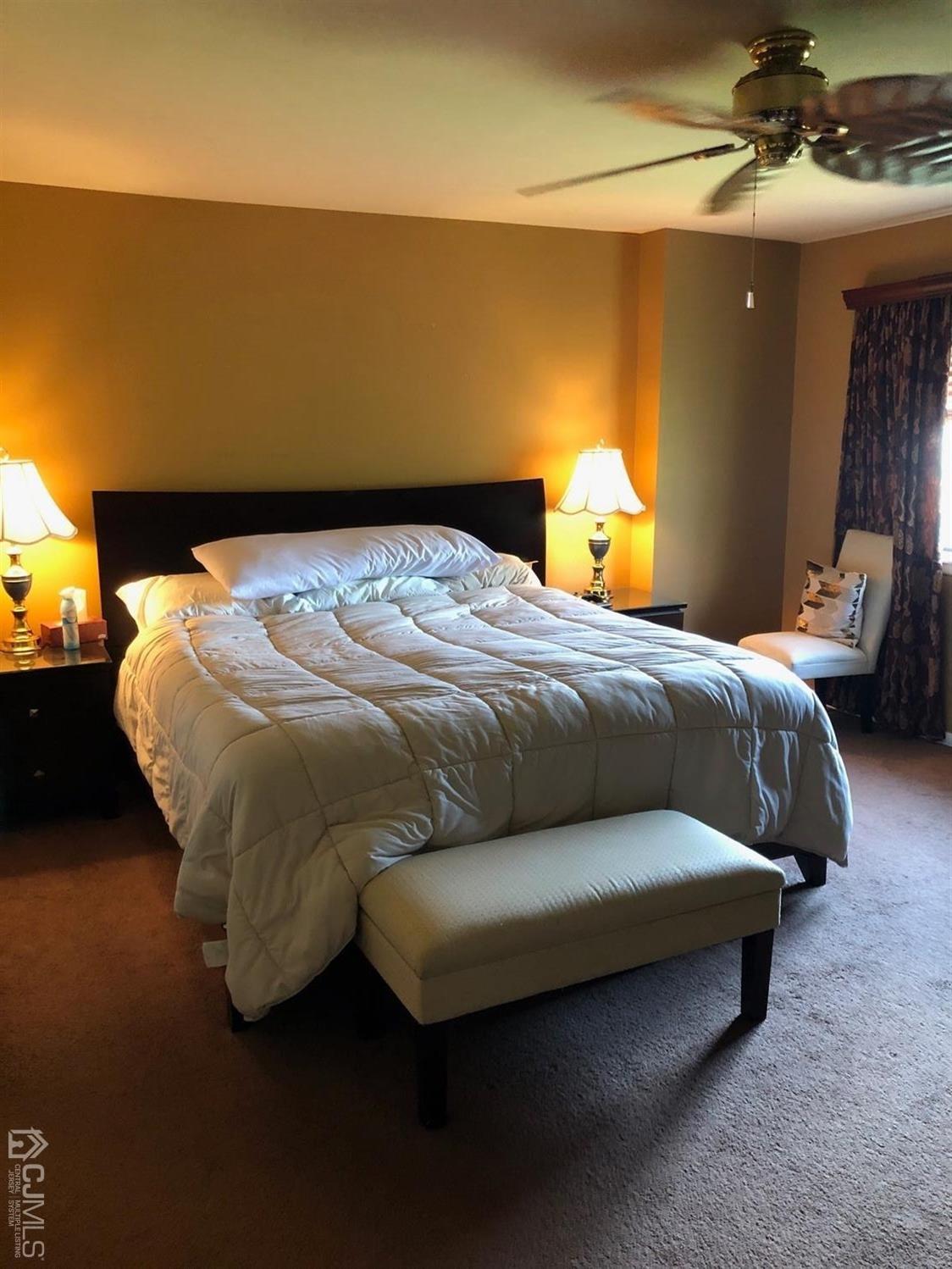 880 Robin Road Hillsborough, NJ 08844 - Photo 25 of 37 a bedroom with a bed and lamp with the screen