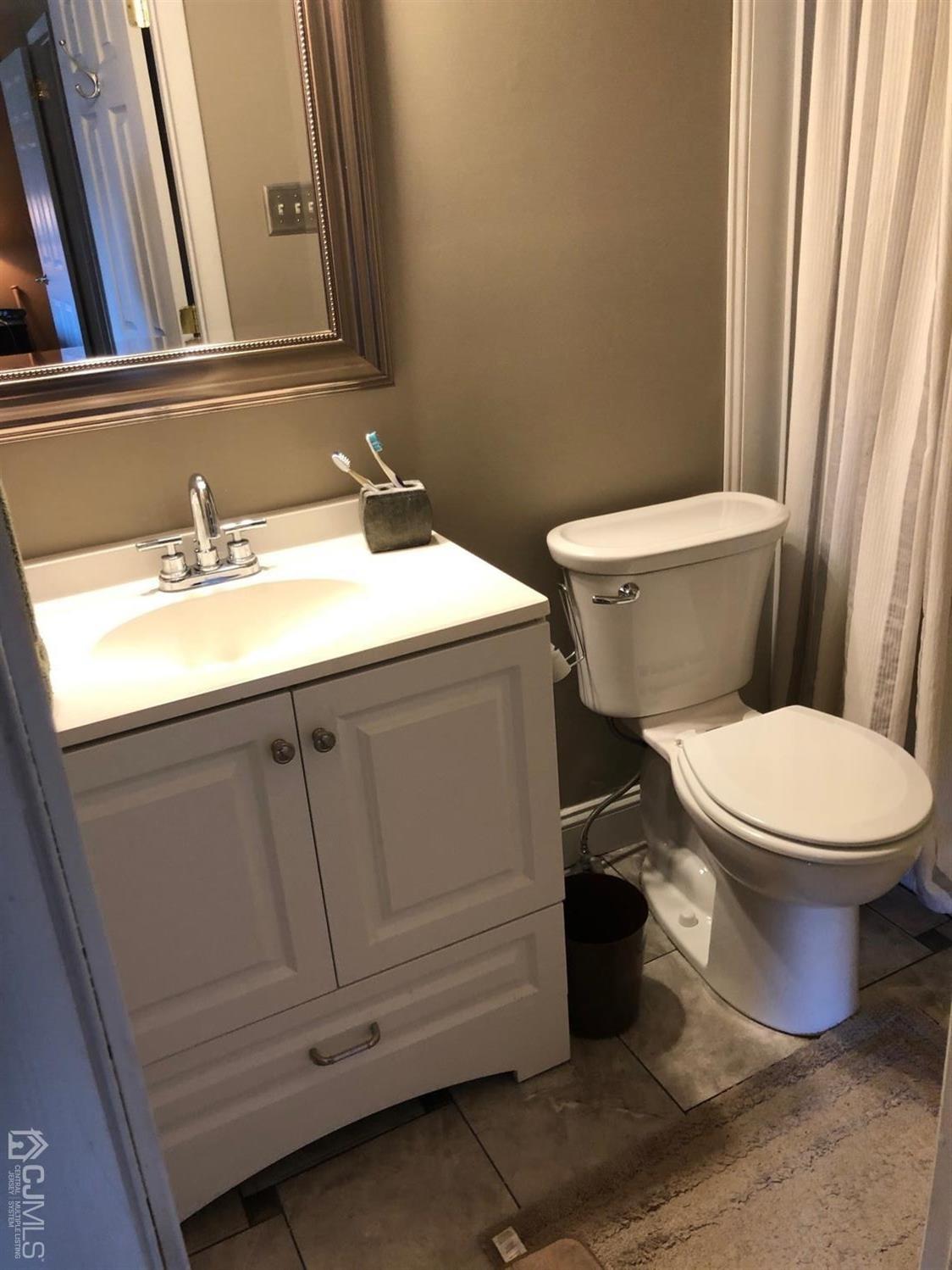 880 Robin Road Hillsborough, NJ 08844 - Photo 27 of 37 a white toilet sitting next to a bathroom sink