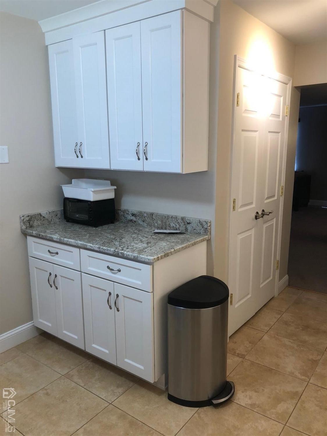 880 Robin Road Hillsborough, NJ 08844 - Photo 5 of 37 a kitchen with granite countertop white cabinets and stainless steel appliances