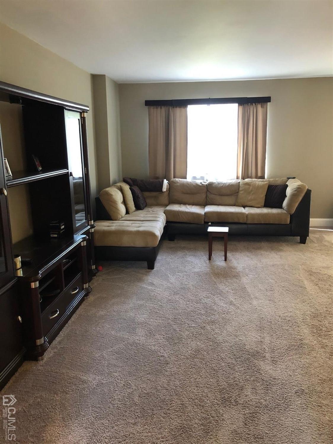 880 Robin Road Hillsborough, NJ 08844 - Photo 8 of 37 a living room with furniture and a window