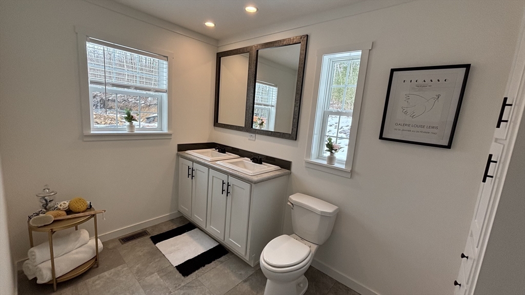 6 Berry Farms Road, Unit 6 Sturbridge, MA 01566 - Photo 12 of 16 a bathroom with a toilet a sink and a window