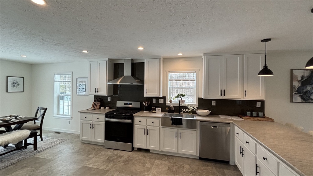 6 Berry Farms Road, Unit 6 Sturbridge, MA 01566 - Photo 6 of 16 a kitchen with a sink stove and cabinets
