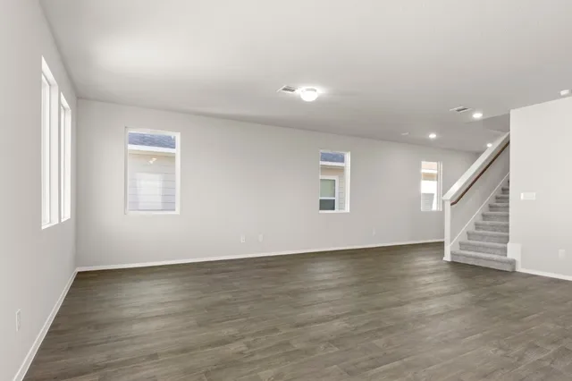 a view of kitchen with kitchen island stainless steel appliances refrigerator oven and microwave
