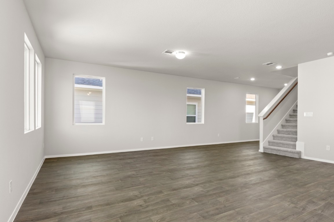 230 Barley Lane Elgin, TX 78621 - Photo 16 of 39 an empty room with wooden floor and windows