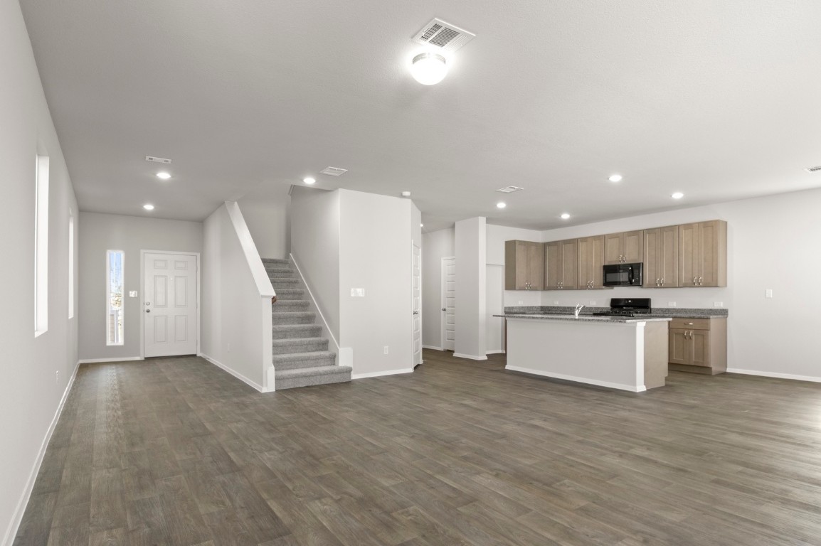 230 Barley Lane Elgin, TX 78621 - Photo 17 of 39 a view of kitchen with kitchen island stainless steel appliances refrigerator oven and microwave