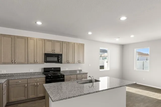 a kitchen with a sink and chandelier