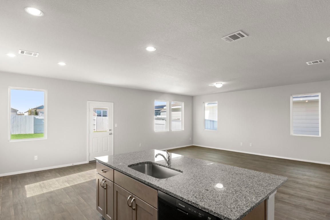230 Barley Lane Elgin, TX 78621 - Photo 25 of 39 a kitchen with a sink and chandelier