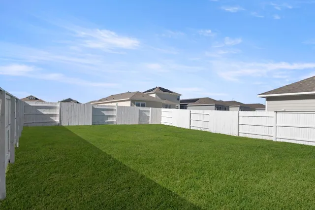 a view of a house with a big yard and a large tree