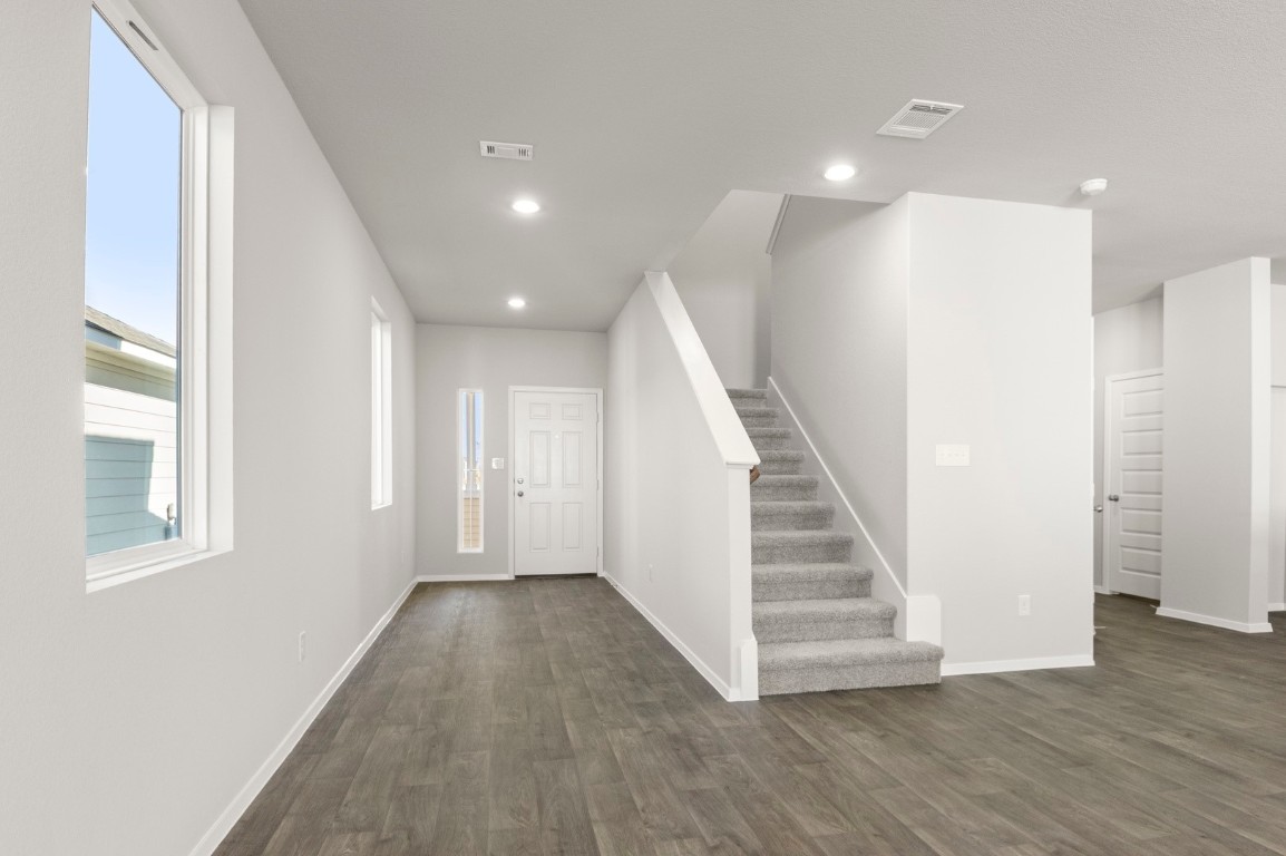 230 Barley Lane Elgin, TX 78621 - Photo 10 of 39 a view of a hallway with wooden floor and entryway