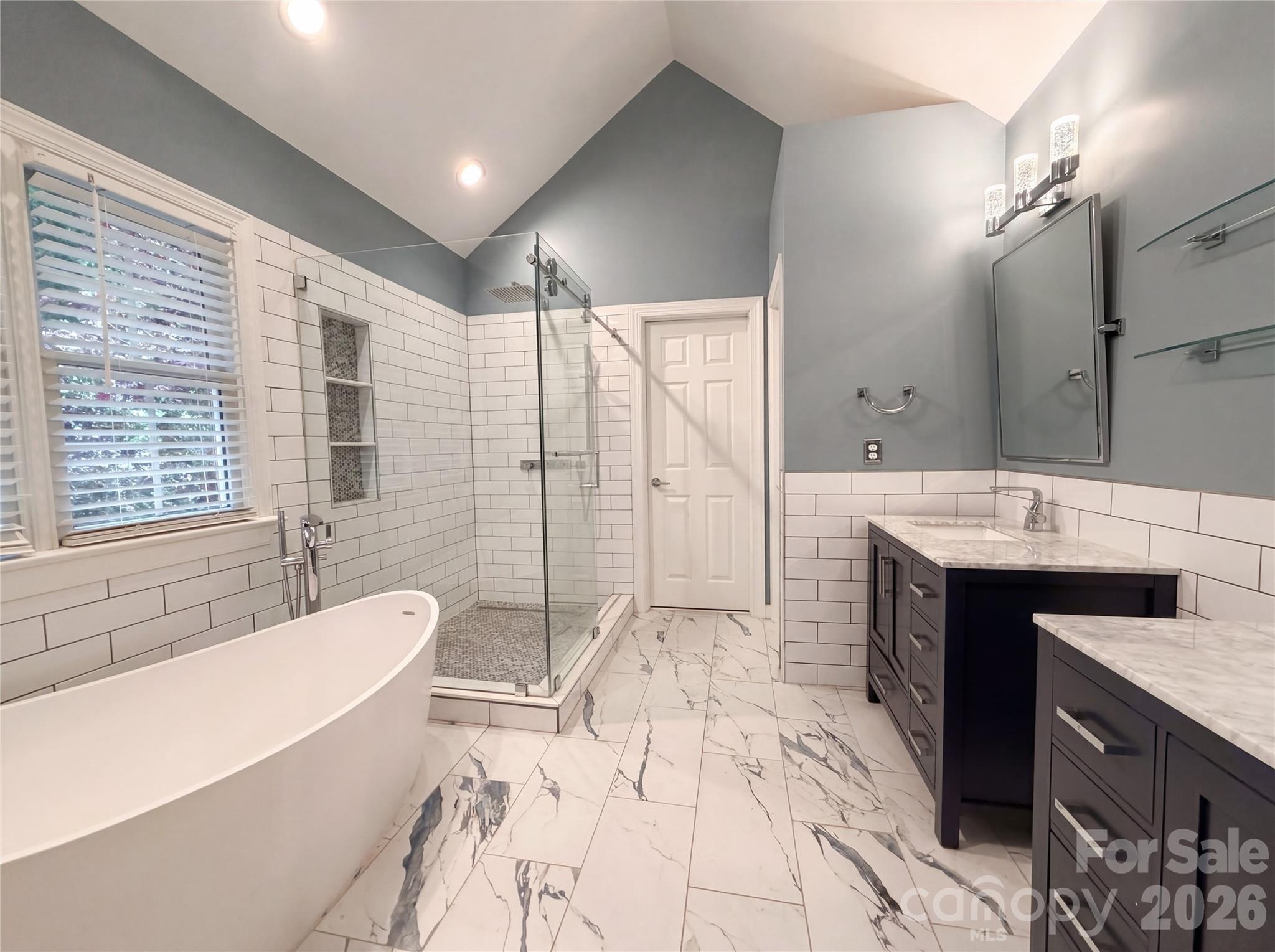 12341 Willingdon Road Huntersville, NC 28078 - Photo 12 of 17 a spacious bathroom with a tub sink shower and a mirror