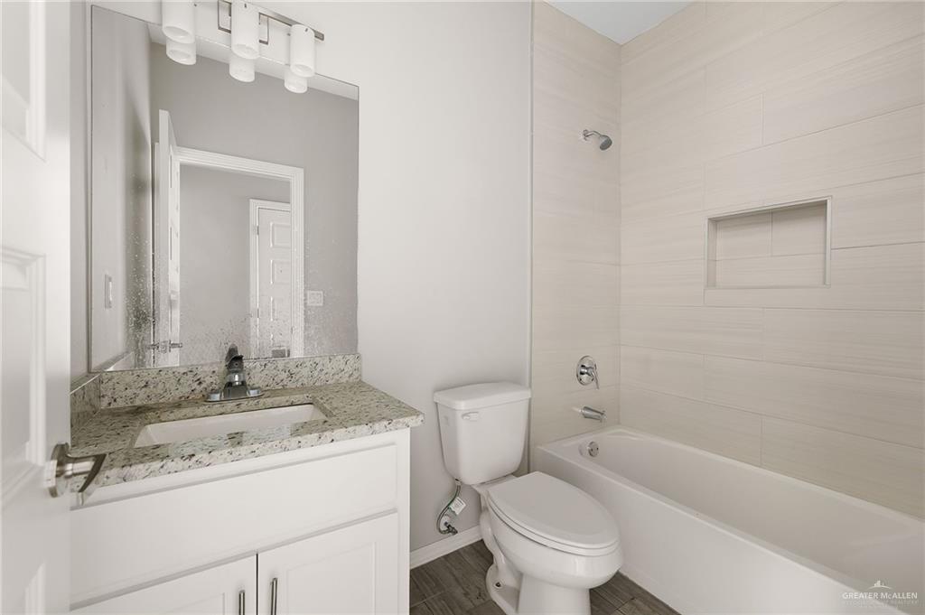 1804 Stauffer Street Weslaco, TX 78596 - Photo 13 of 17 a bathroom with a sink a toilet and shower