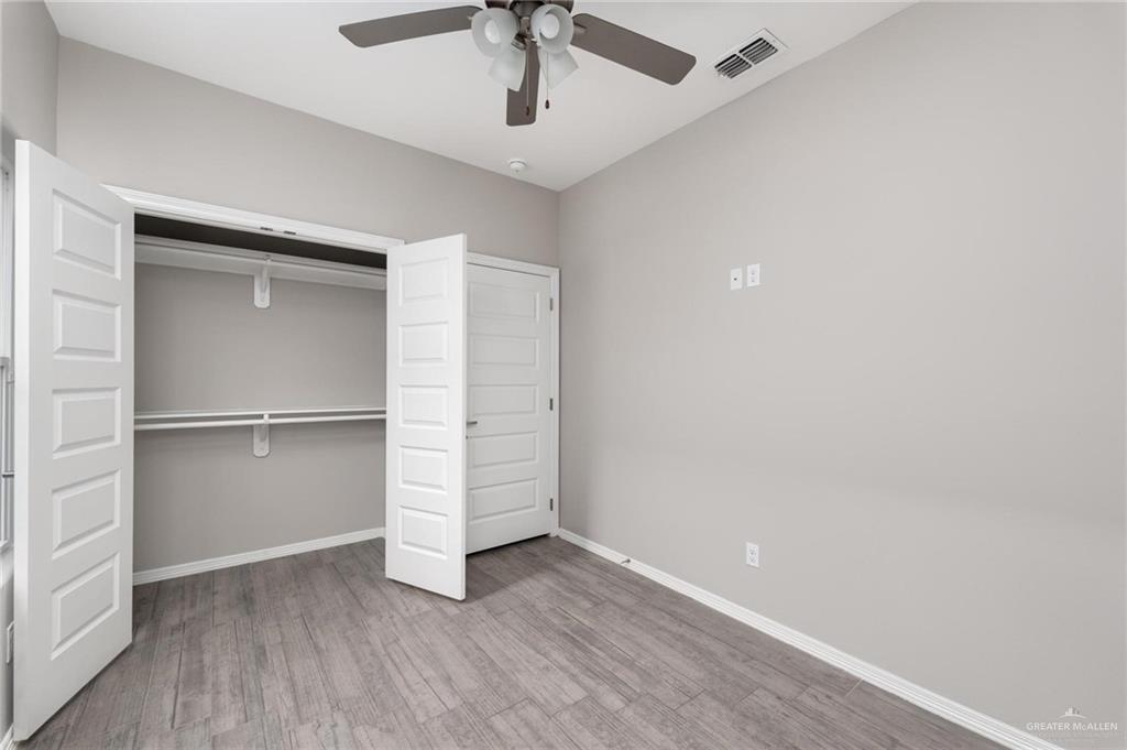 1804 Stauffer Street Weslaco, TX 78596 - Photo 14 of 23 an empty room with a hardwood and ceiling fan