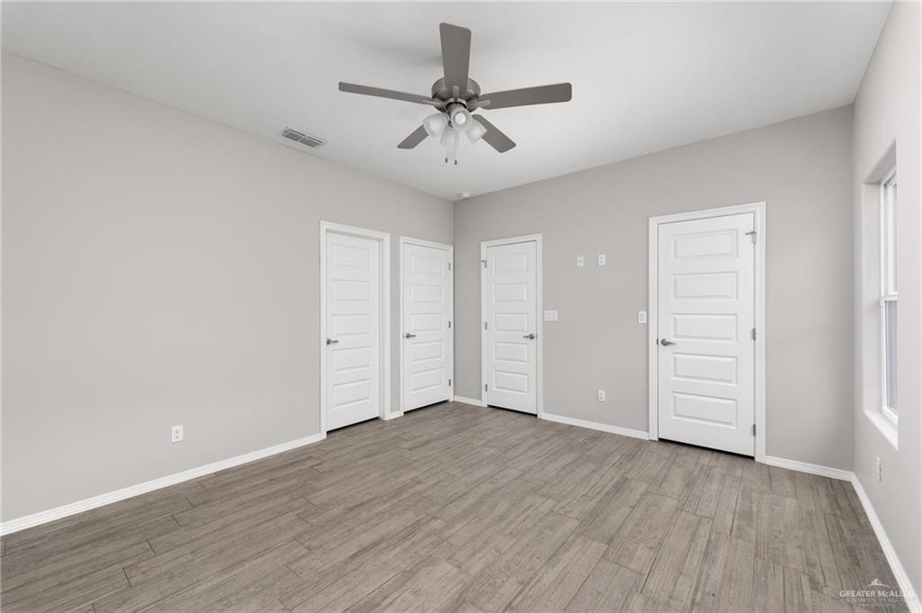 1804 Stauffer Street Weslaco, TX 78596 - Photo 16 of 23 wooden floor in an empty room with a window