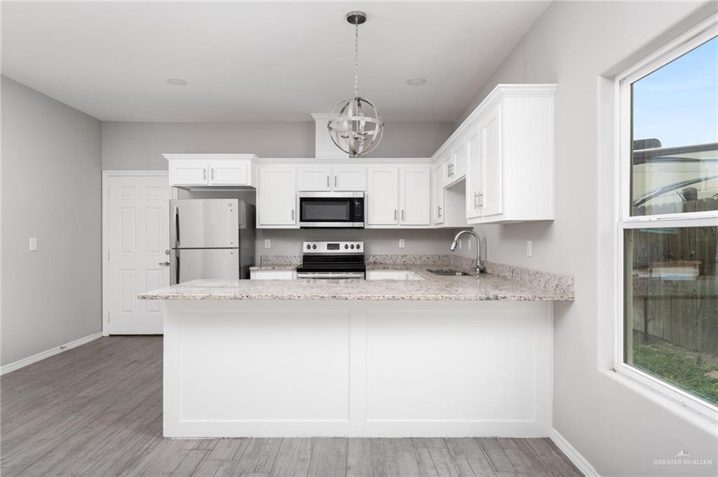 1804 Stauffer Street Weslaco, TX 78596 - Photo 5 of 23 a view of kitchen with stainless steel appliances granite countertop refrigerator stove microwave and sink