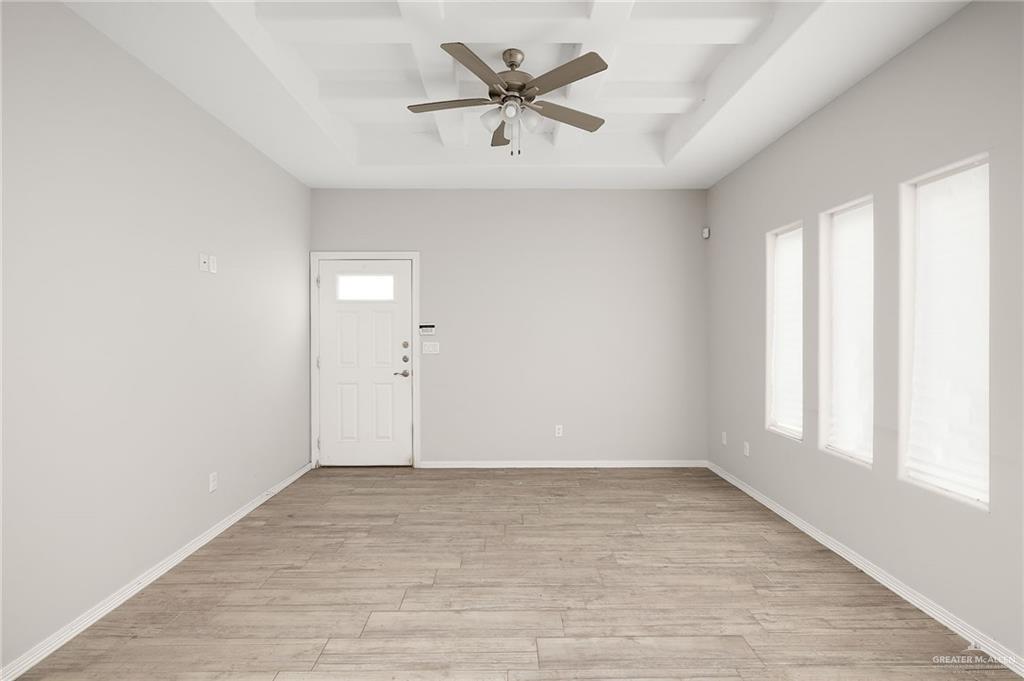 1804 Stauffer Street Weslaco, TX 78596 - Photo 6 of 17 wooden floor in an empty room with a window