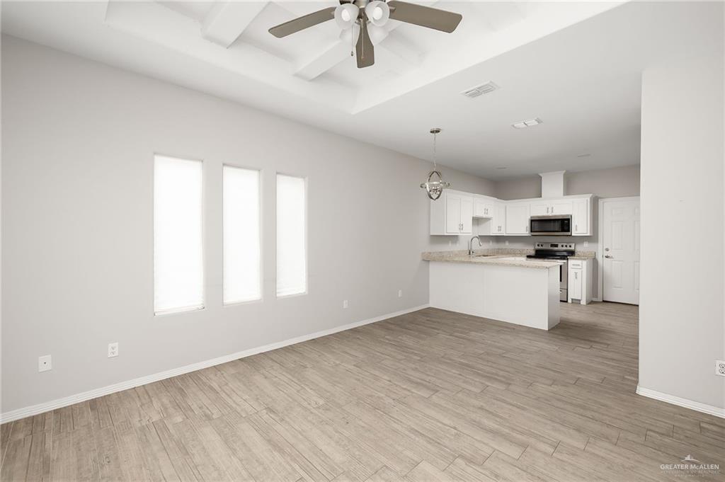 1804 Stauffer Street Weslaco, TX 78596 - Photo 7 of 17 a view of kitchen with granite countertop cabinets and window