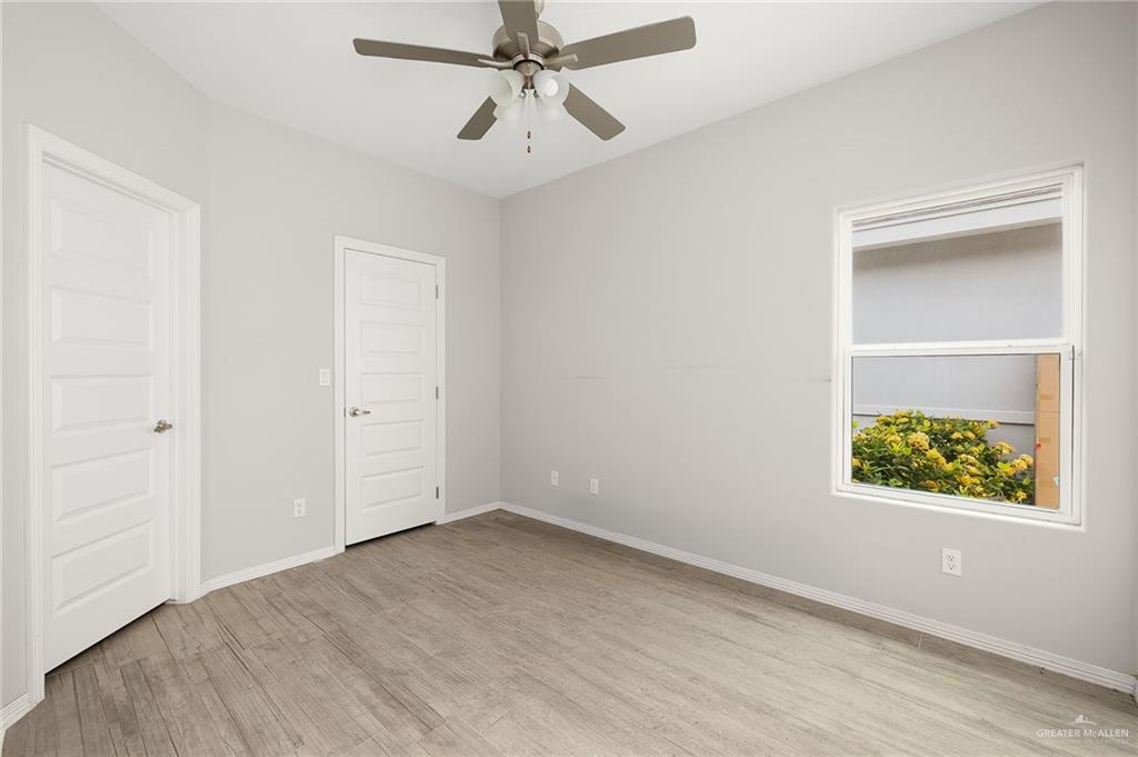 1804 Stauffer Street Weslaco, TX 78596 - Photo 10 of 17 an empty room with a window and ceiling fan