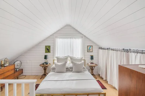 a bed room with a bed and a window