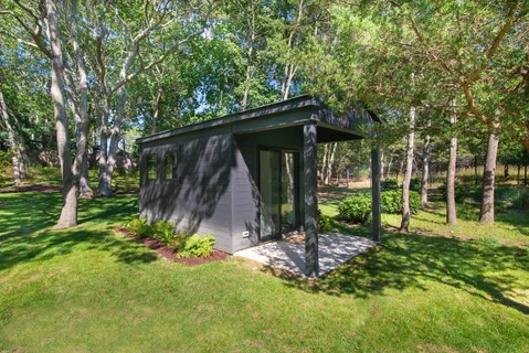 a view of a chair and table in backyard of the house