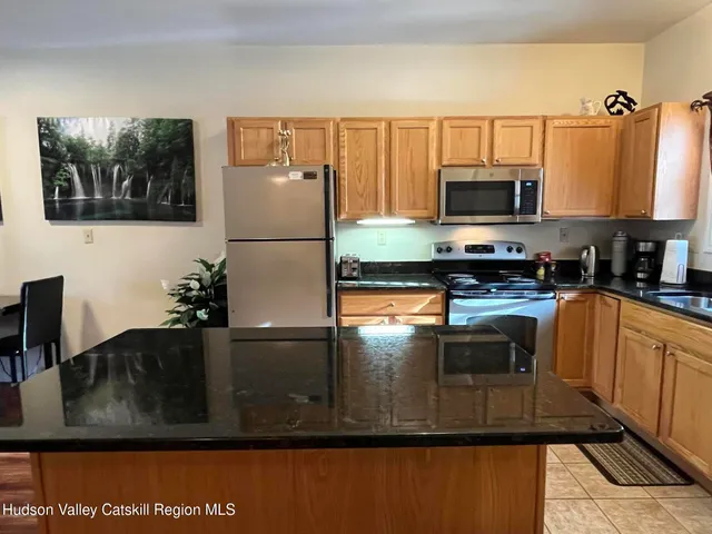a kitchen with a sink a stove and microwave