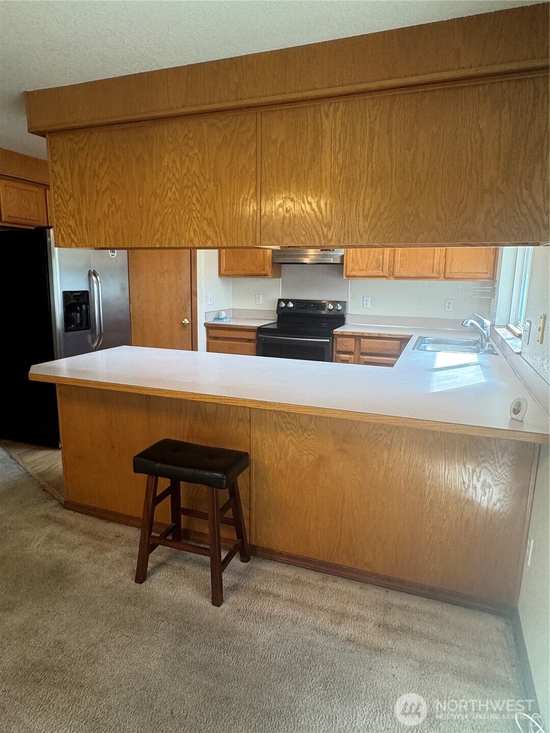 5920 Compton Loop Southeast Lacey, WA 98513 - Photo 15 of 37 a workspace with stainless steel appliances kitchen island