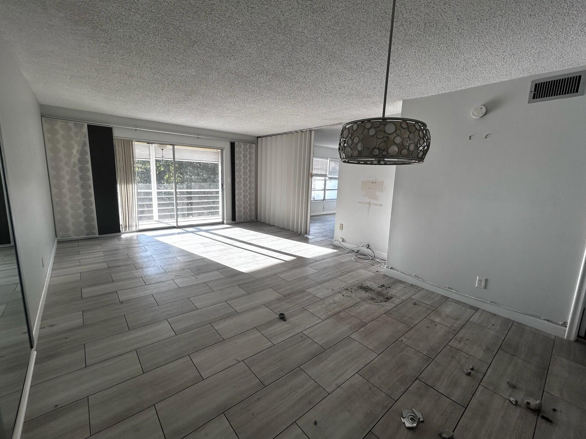 3776 Inverrary Boulevard, Unit 304R Lauderhill, FL 33319 - Photo 7 of 23 a view of an empty room with a window and a kitchen