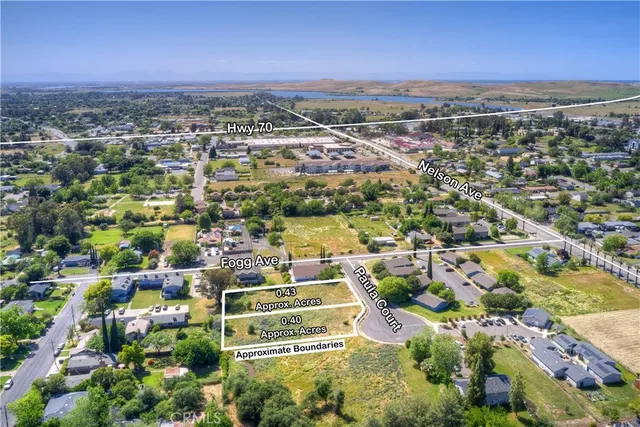 an aerial view of residential building with parking and yard