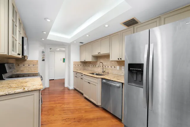 a bed sitting in a bedroom next to a window with lamp