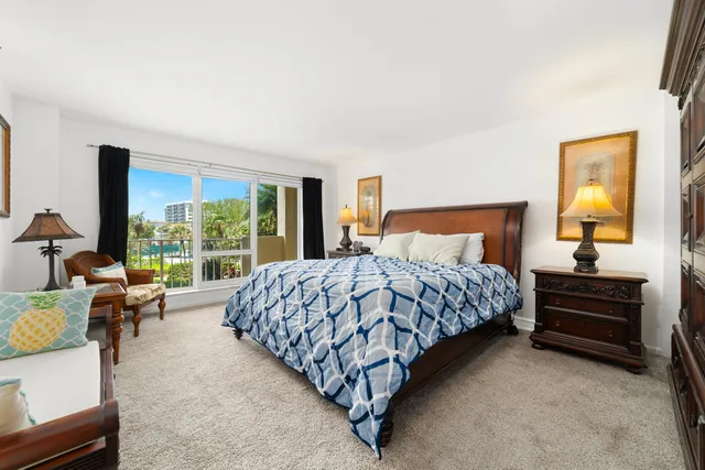 a bedroom with a bed chair and a window