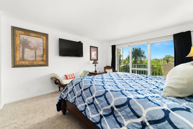 a bedroom with a bed and a television