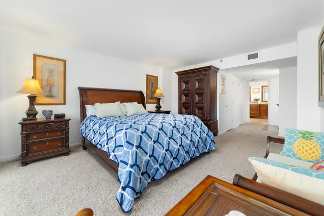 a bathroom with a granite countertop sink a toilet a mirror and shower