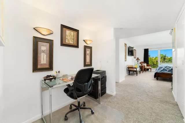 a view of a livingroom with wooden floor and furniture