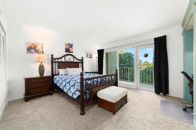 a view of a patio with a table and chairs under an umbrella