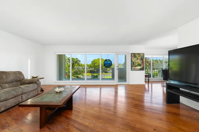a living room with furniture and large windows