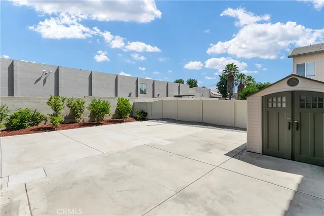 a view of a house with a yard and potted plants