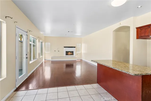 a kitchen with granite countertop a stove and a granite counter tops with white walls
