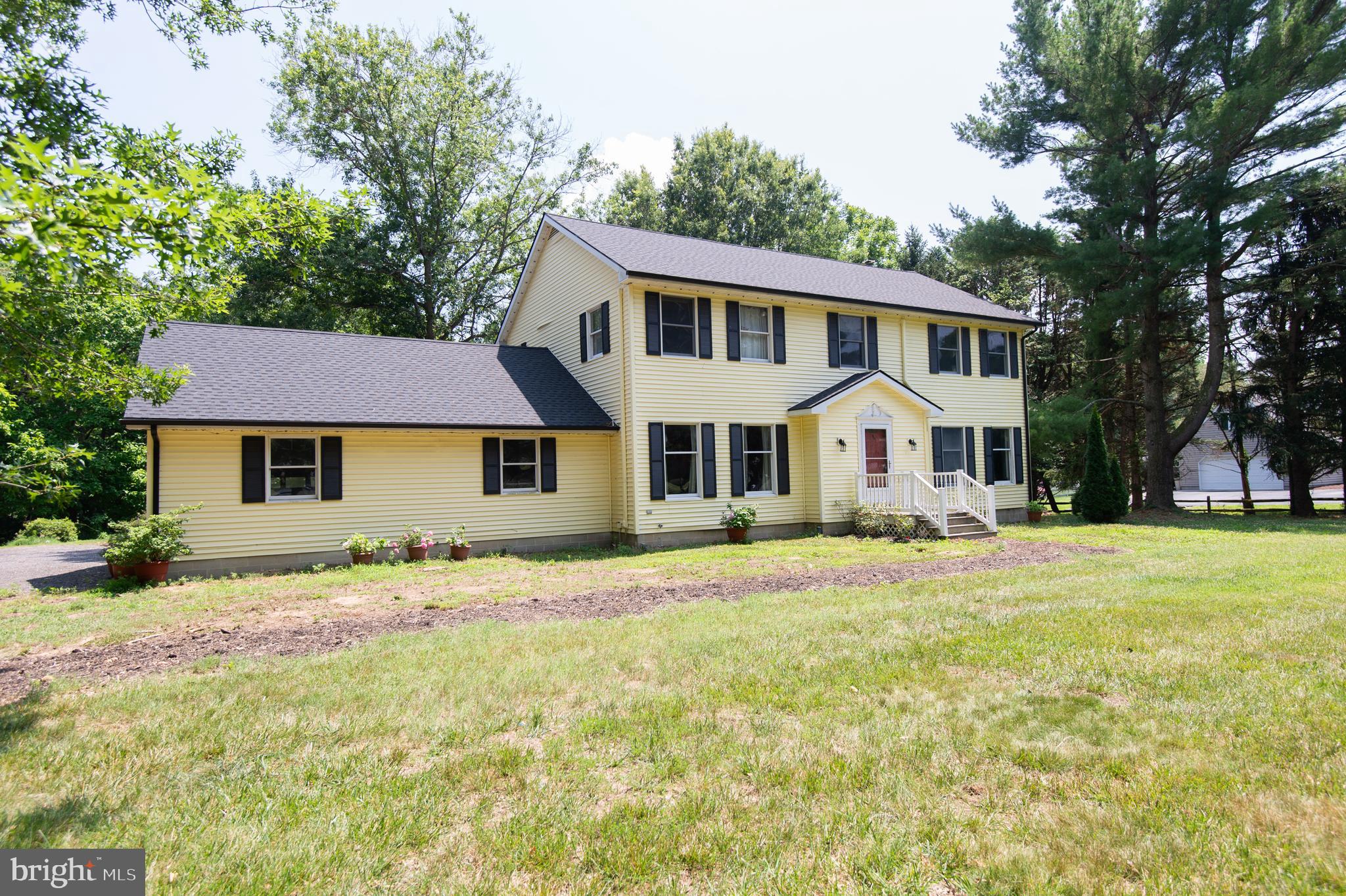 9472 Quail Run Road Denton, MD 21629 - Photo 34 of 50 a view of a white house with a big yard and large trees