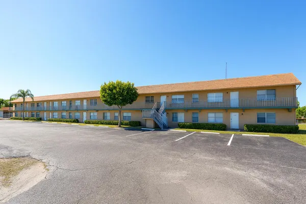 a view of a building with a yard