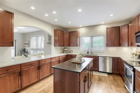 a kitchen with a sink stove and cabinets