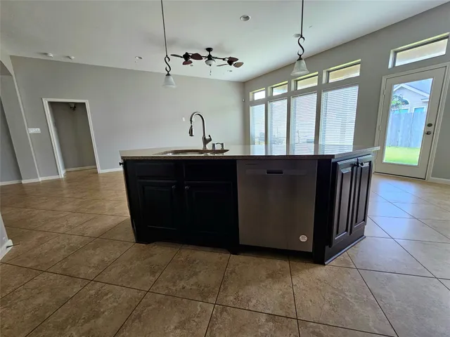 a kitchen with a sink and cabinets