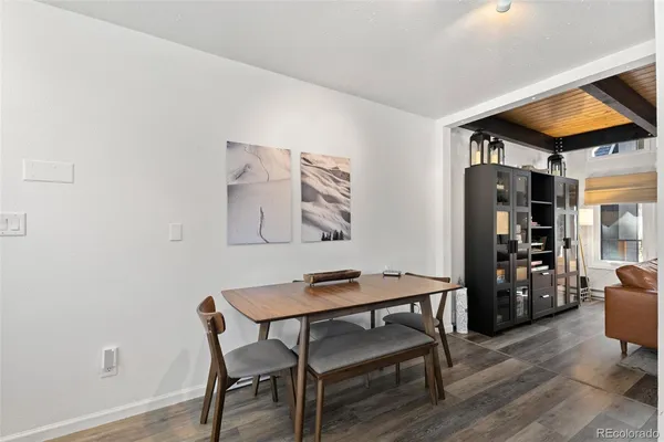 a view of a workspace with furniture and wooden floor