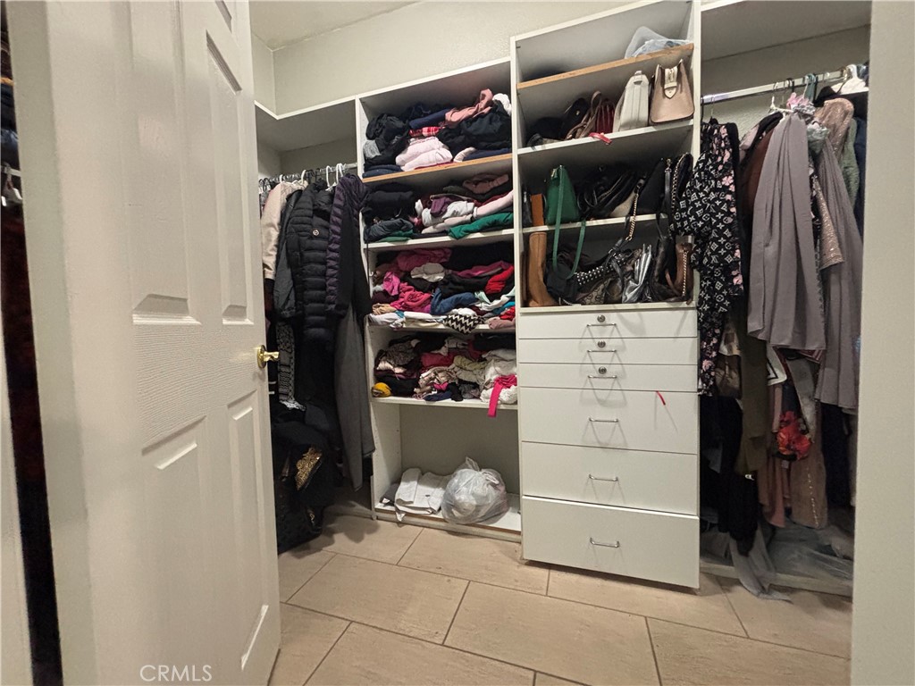 11571 Trailrun Court Riverside, CA 92505 - Photo 13 of 18 a view of walk in closet with clothes and shoes