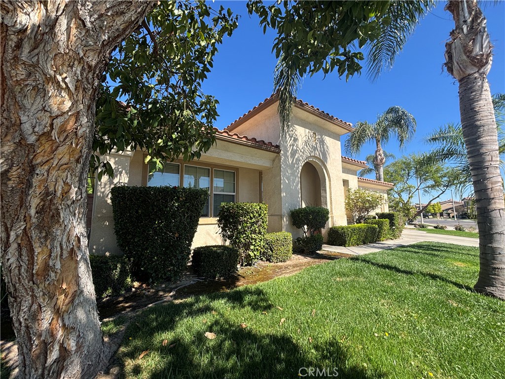 11571 Trailrun Court Riverside, CA 92505 - Photo 2 of 18 a front view of a house with garden