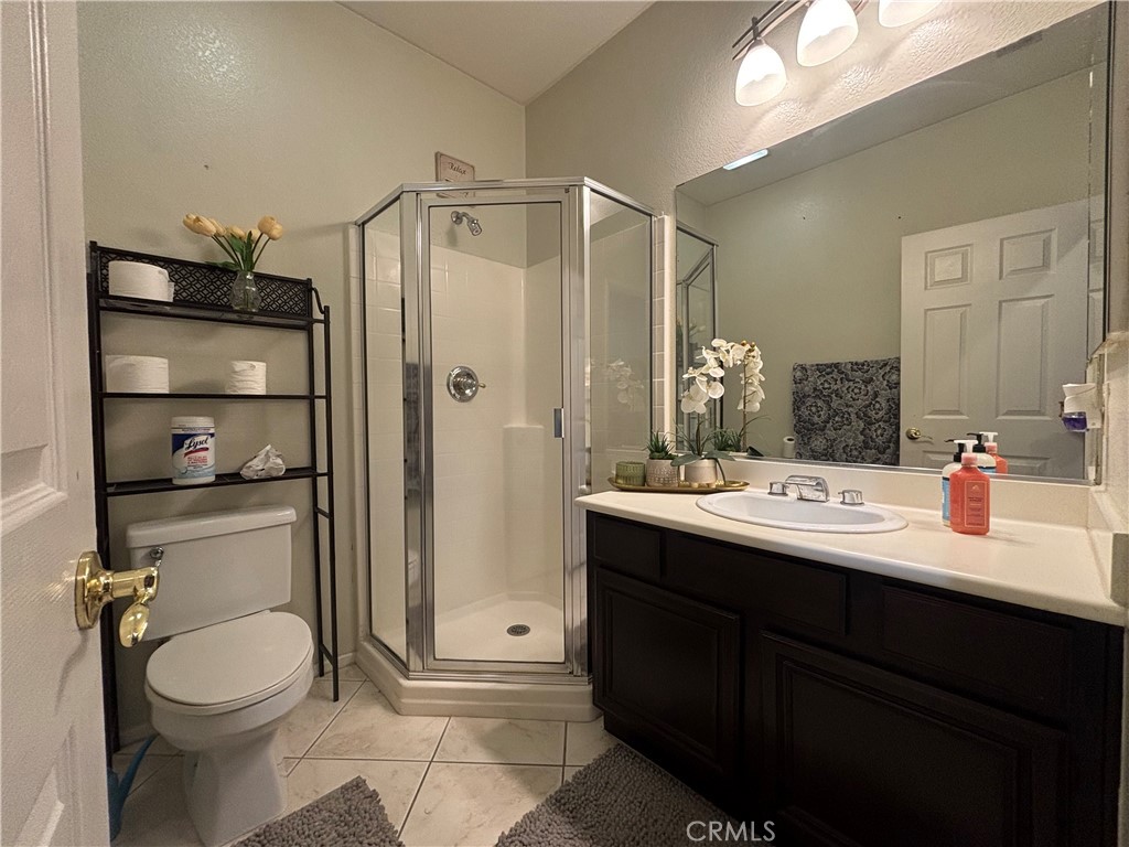 11571 Trailrun Court Riverside, CA 92505 - Photo 6 of 18 a bathroom with a sink a toilet and shower